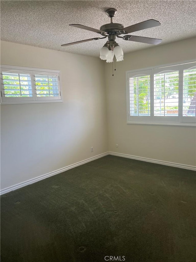 2306 S Rene Dr, Santa Ana, CA 92704 - empty room with healthy amount of natural light, dark colored carpet, a ceiling fan, baseboards, and a textured ceiling