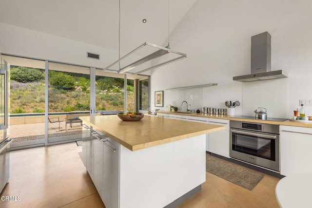 12179 Koenigstein Rd, Santa Paula, CA 93060 - kitchen with appliances with stainless steel finishes, wall chimney exhaust hood, modern cabinets, a sink, and light countertops