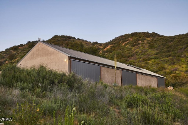 12179 Koenigstein Rd, Santa Paula, CA 93060 - view of side of home with metal roof, a mountain view, an outbuilding, and a pole building