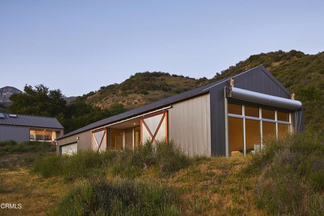12179 Koenigstein Rd, Santa Paula, CA 93060 - view of home's exterior with a mountain view, a garage, and an outbuilding