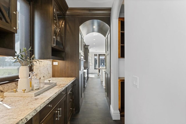 2574 Muirfields Dr, Carlsbad, CA 92009 - bar area with healthy amount of natural light, dark wood-type flooring, arched walkways, stainless steel oven, and crown molding