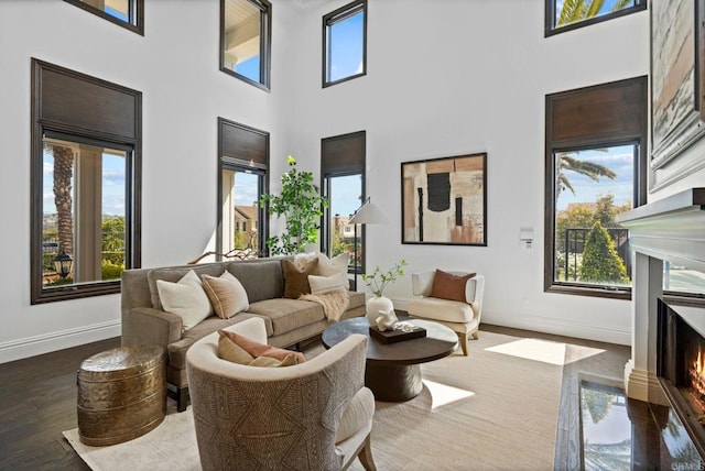 2574 Muirfields Dr, Carlsbad, CA 92009 - living room featuring a high end fireplace, baseboards, a high ceiling, and wood finished floors