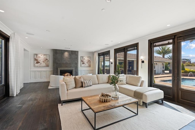 2574 Muirfields Dr, Carlsbad, CA 92009 - living area featuring plenty of natural light, ornamental molding, wood finished floors, recessed lighting, and a fireplace