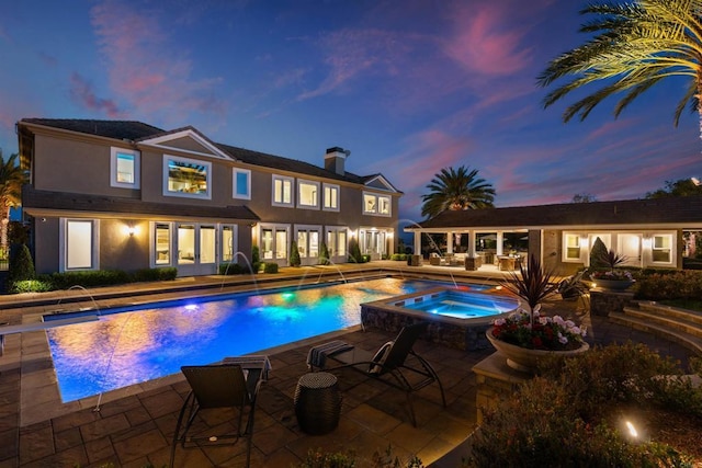 2574 Muirfields Dr, Carlsbad, CA 92009 - pool at dusk featuring an in-ground hot tub, an outdoor pool, and a patio area