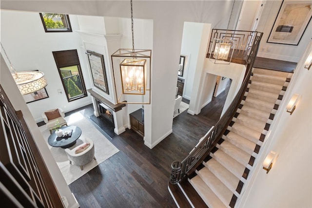 2574 Muirfields Dr, Carlsbad, CA 92009 - stairs with a chandelier, healthy amount of natural light, wood finished floors, baseboards, and a towering ceiling