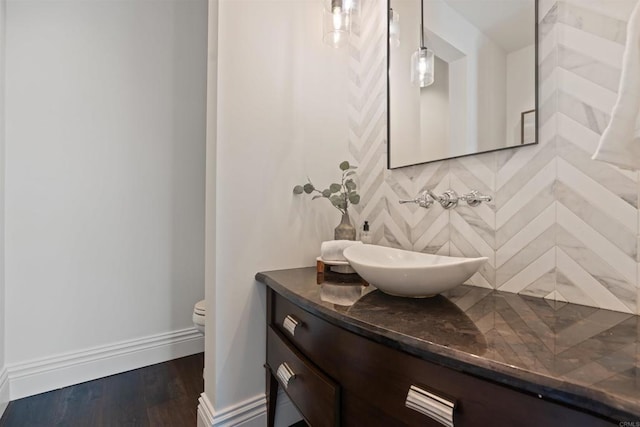 2574 Muirfields Dr, Carlsbad, CA 92009 - bathroom with backsplash, vanity, toilet, and wood finished floors