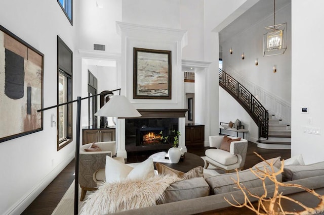 2574 Muirfields Dr, Carlsbad, CA 92009 - living area with a towering ceiling, wood finished floors, stairway, a premium fireplace, and healthy amount of natural light