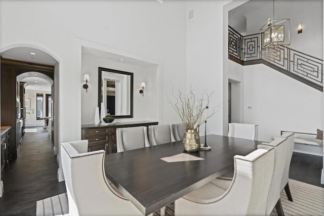 2574 Muirfields Dr, Carlsbad, CA 92009 - dining area with a chandelier, a high ceiling, dark wood-style floors, and arched walkways