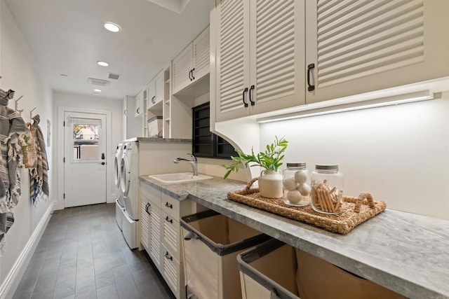 2574 Muirfields Dr, Carlsbad, CA 92009 - kitchen featuring washer and clothes dryer, a sink, baseboards, recessed lighting, and white cabinetry