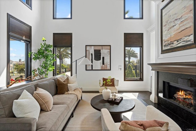 2574 Muirfields Dr, Carlsbad, CA 92009 - living room with a towering ceiling, a premium fireplace, and wood finished floors
