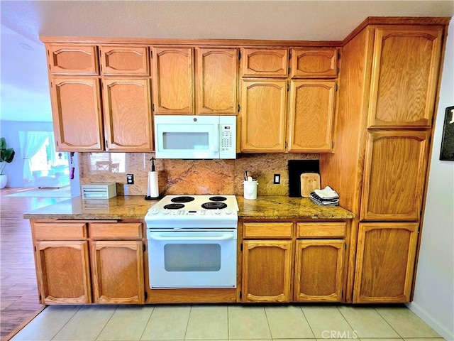 39560 S Lilley Way, Coarsegold, CA 93614 - kitchen with white appliances, decorative backsplash, and brown cabinetry