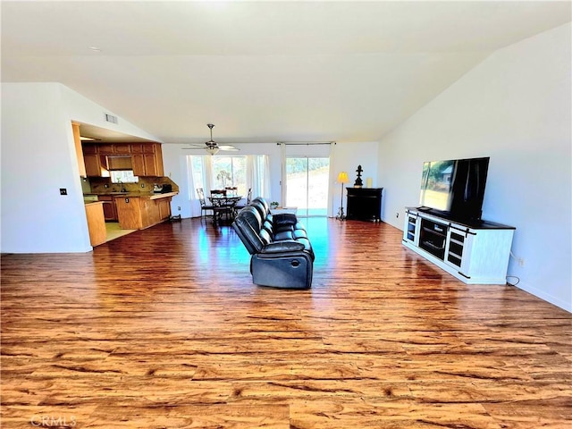 39560 S Lilley Way, Coarsegold, CA 93614 - living room featuring wood finished floors, lofted ceiling, a ceiling fan, and baseboards