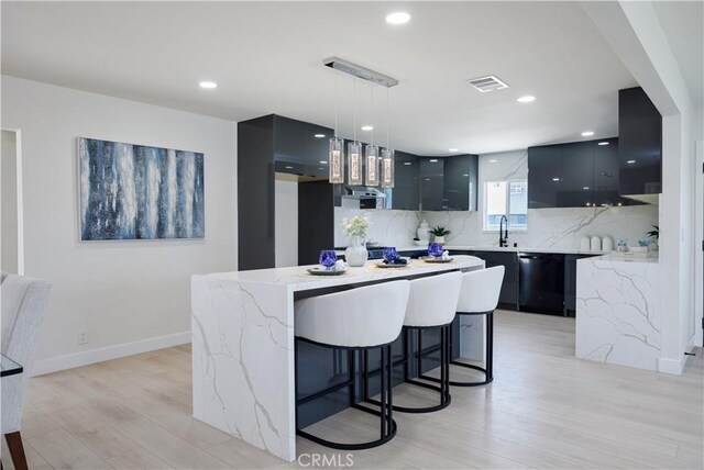 13502 Jackson St, Westminster, CA 92683 - kitchen with modern cabinets, black dishwasher, light wood-type flooring, pendant lighting, and decorative backsplash