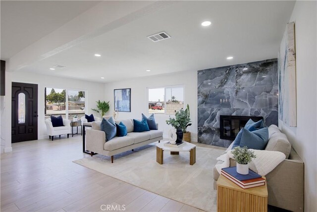 13502 Jackson St, Westminster, CA 92683 - living room with light wood-type flooring, a high end fireplace, and recessed lighting