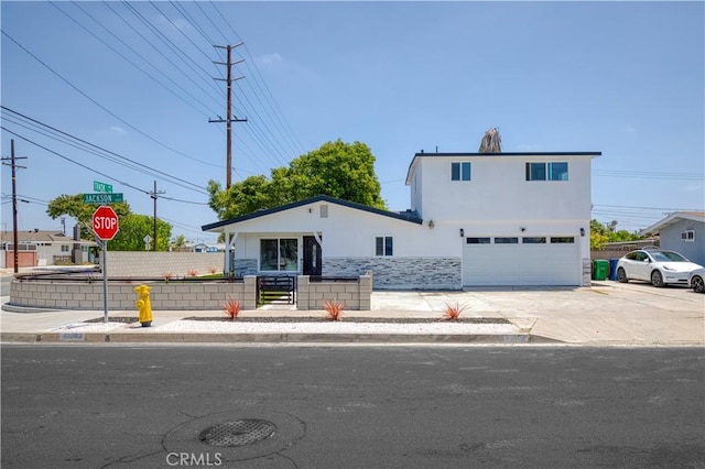 13502 Jackson St, Westminster, CA 92683 - view of front of property featuring a garage, stucco siding, stone siding, and concrete driveway