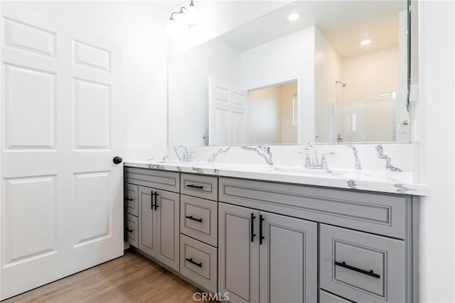 21402 Short Ridge Ave, Perris, CA 92570 - bathroom with double vanity, wood finished floors, and a shower