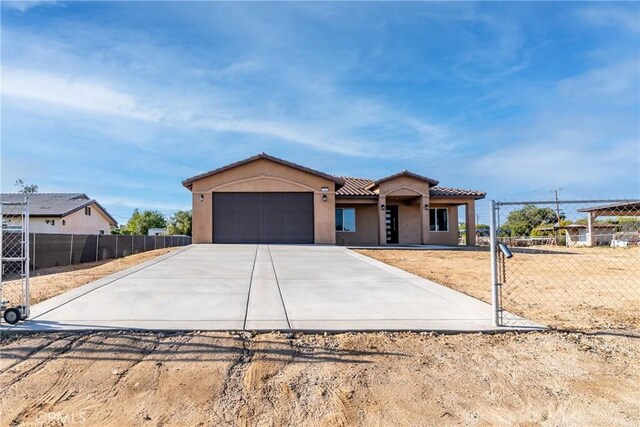 21402 Short Ridge Ave, Perris, CA 92570 - mediterranean / spanish-style home featuring driveway, a garage, stucco siding, and a tile roof