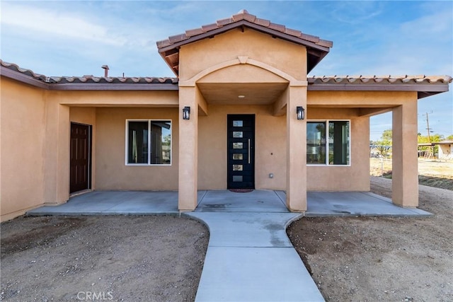 21402 Short Ridge Ave, Perris, CA 92570 - entrance to property featuring stucco siding and a tiled roof