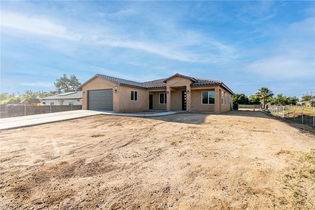 21402 Short Ridge Ave, Perris, CA 92570 - view of front of home featuring concrete driveway, an attached garage, a tiled roof, and stucco siding