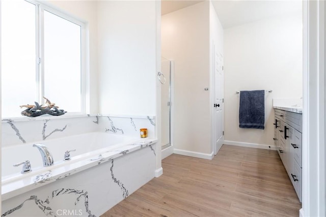 21402 Short Ridge Ave, Perris, CA 92570 - full bath featuring vanity, a bath, wood finished floors, baseboards, and a stall shower
