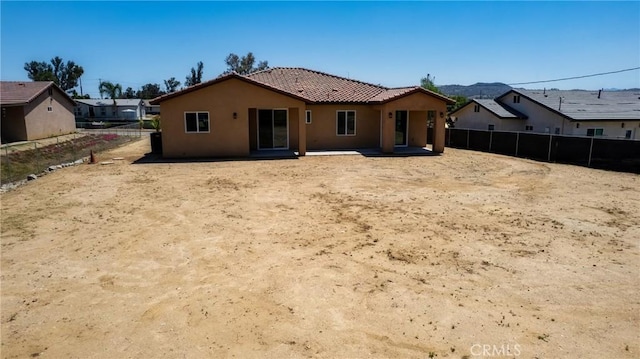 21402 Short Ridge Ave, Perris, CA 92570 - back of property featuring a tiled roof, stucco siding, and a patio