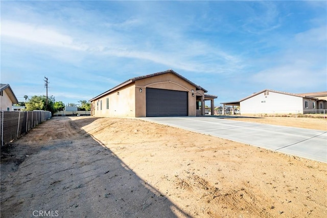 21402 Short Ridge Ave, Perris, CA 92570 - view of front of house with driveway, an attached garage, and stucco siding