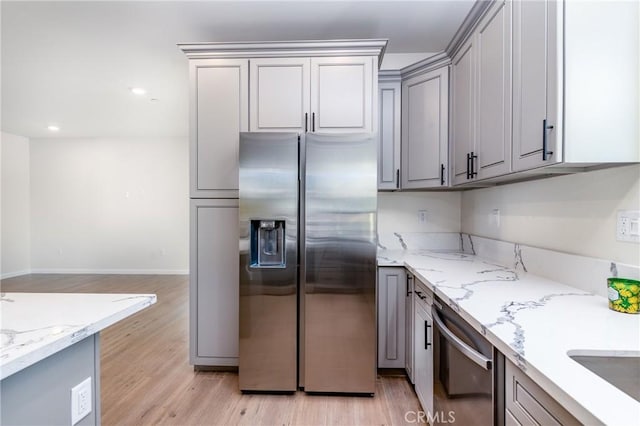 21402 Short Ridge Ave, Perris, CA 92570 - kitchen with appliances with stainless steel finishes, gray cabinets, light wood-style floors, light stone counters, and baseboards