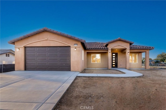 21402 Short Ridge Ave, Perris, CA 92570 - view of front facade with stucco siding, a tile roof, a garage, and driveway