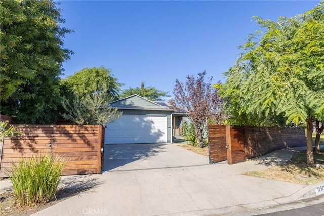 16921 Lanark St, Van Nuys, CA 91406 - view of front of house with concrete driveway, a garage, and a gate