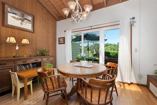 31531 Via Conejo Unit 153, Coto De Caza, CA 92679 - dining area with vaulted ceiling, light wood finished floors, wood walls, wood ceiling, and a chandelier
