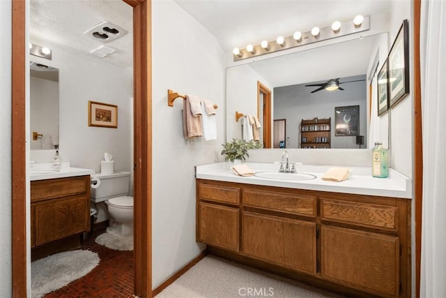 31531 Via Conejo Unit 153, Coto De Caza, CA 92679 - bathroom featuring vanity, ceiling fan, toilet, baseboards, and brick patterned flooring