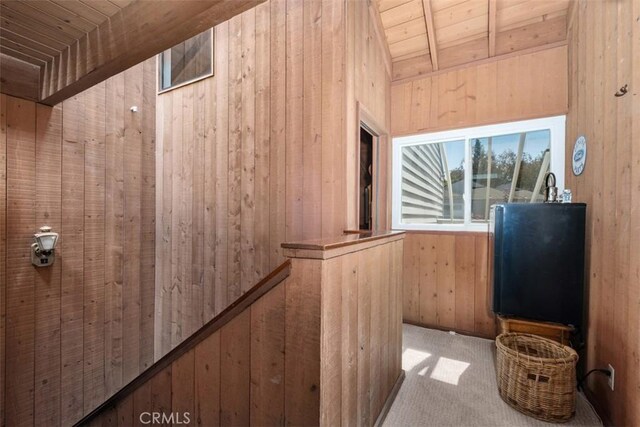 31531 Via Conejo Unit 153, Coto De Caza, CA 92679 - corridor featuring wood ceiling with exposed beams, wood walls, and carpet floors