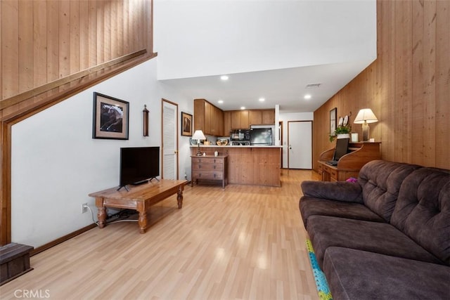 31531 Via Conejo Unit 153, Coto De Caza, CA 92679 - living area featuring a towering ceiling, wooden walls, light wood finished floors, and recessed lighting
