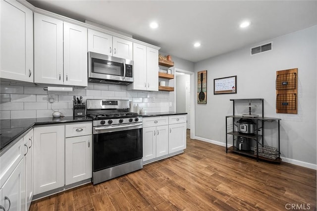 8506 Conway Dr, Riverside, CA 92504 - kitchen featuring stainless steel appliances, baseboards, backsplash, open shelves, and dark wood-type flooring