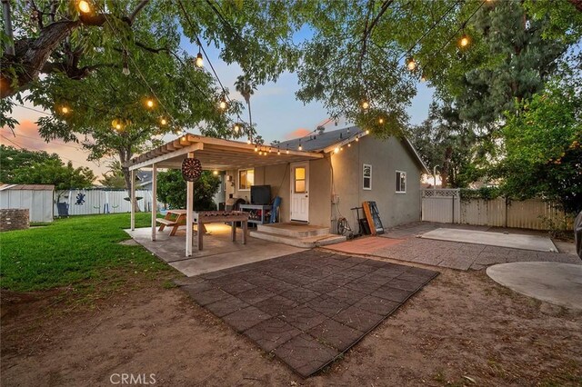 8506 Conway Dr, Riverside, CA 92504 - back of property at dusk with a patio and stucco siding