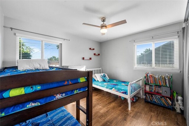 8506 Conway Dr, Riverside, CA 92504 - bedroom featuring multiple windows, wood finished floors, a ceiling fan, and baseboards