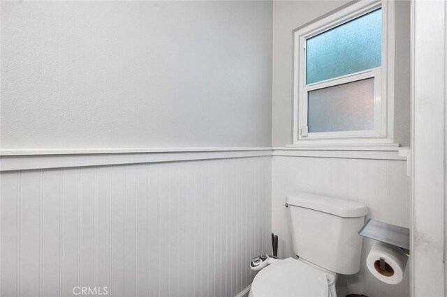 8506 Conway Dr, Riverside, CA 92504 - bathroom with a wainscoted wall and toilet