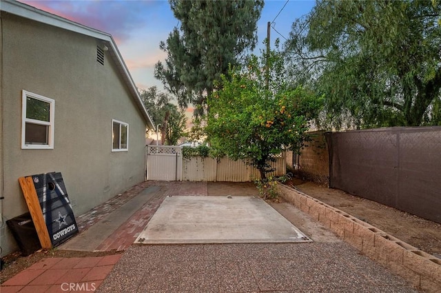 8506 Conway Dr, Riverside, CA 92504 - patio terrace at dusk featuring a patio area and a fenced backyard