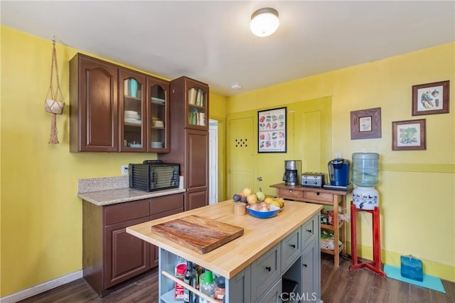 471 N Ditman Ave, Los Angeles, CA 90063 - kitchen with butcher block counters, baseboards, dark wood finished floors, open shelves, and glass insert cabinets