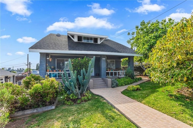 471 N Ditman Ave, Los Angeles, CA 90063 - bungalow with a porch, a front yard, roof with shingles, and stucco siding