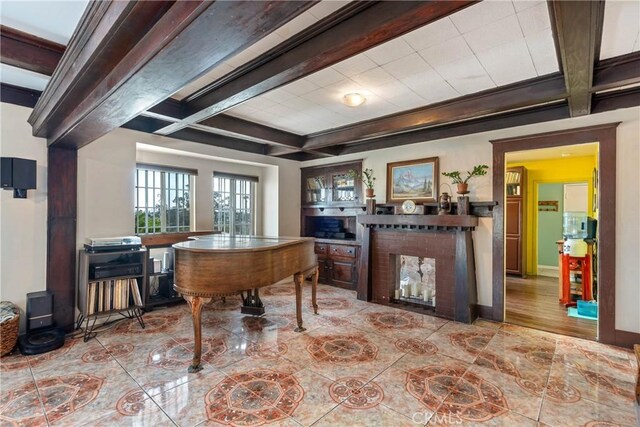 471 N Ditman Ave, Los Angeles, CA 90063 - tiled home office featuring beamed ceiling, coffered ceiling, a wood stove, a fireplace, and baseboards