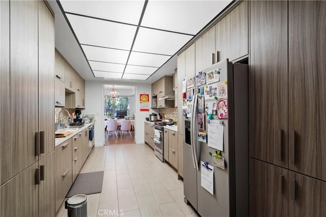 241 S Reeves Dr Unit 302, Beverly Hills, CA 90212 - kitchen with appliances with stainless steel finishes, extractor fan, light countertops, backsplash, and a sink