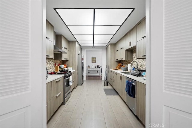 241 S Reeves Dr Unit 302, Beverly Hills, CA 90212 - kitchen featuring stainless steel appliances, light countertops, decorative backsplash, and wall chimney range hood