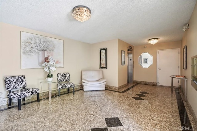 241 S Reeves Dr Unit 302, Beverly Hills, CA 90212 - foyer entrance featuring baseboards, a textured ceiling, elevator, and granite floors
