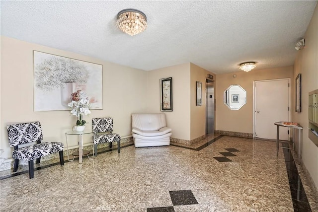 241 S Reeves Dr Unit 302, Beverly Hills, CA 90212 - entrance foyer with a textured ceiling, elevator, and granite tiled floors