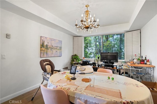 241 S Reeves Dr Unit 302, Beverly Hills, CA 90212 - dining space featuring a chandelier, wood finished floors, baseboards, and a tray ceiling