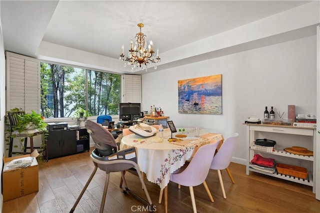 241 S Reeves Dr Unit 302, Beverly Hills, CA 90212 - dining room featuring wood-type flooring, a chandelier, a raised ceiling, a desk, and baseboards