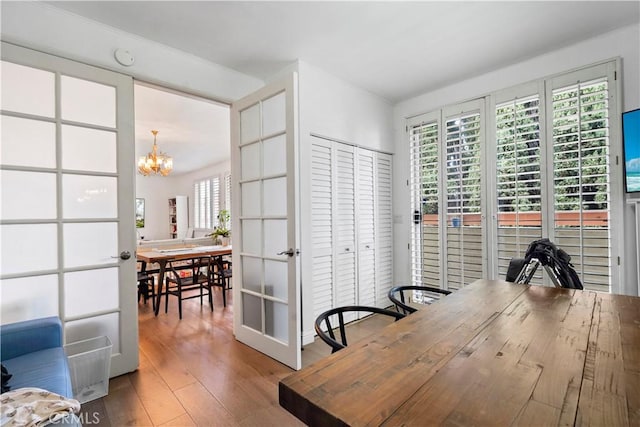 241 S Reeves Dr Unit 302, Beverly Hills, CA 90212 - dining area featuring a chandelier and wood finished floors
