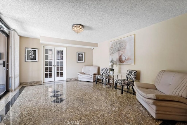 241 S Reeves Dr Unit 302, Beverly Hills, CA 90212 - sitting room with french doors, granite tiled floors, a textured ceiling, and baseboards