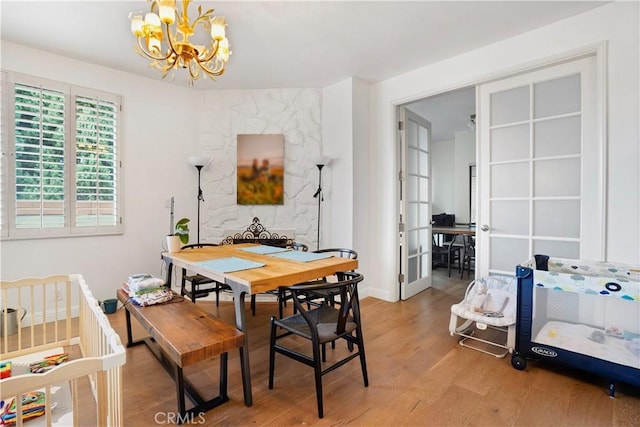 241 S Reeves Dr Unit 302, Beverly Hills, CA 90212 - dining room featuring a chandelier, wood finished floors, and baseboards